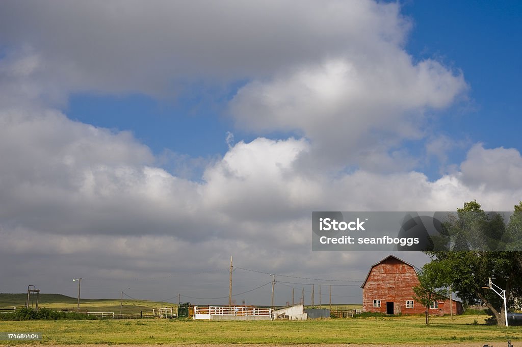 Red Farm Barn with blue sky and clouds in Kansas Red Farm Barn with blue sky and clouds in Kansas and copy-space. Farm Stock Photo