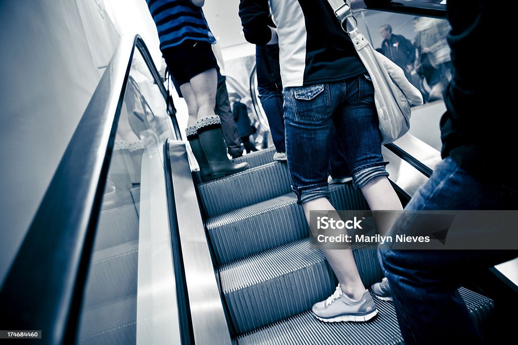 going up Escalator with people on it. Architectural Feature Stock Photo