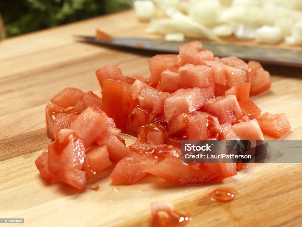 Diced Tomatoes on Cutting Board Diced Tomatoes on Cutting Board -Photographed on Hasselblad H3D-39mb Camera Chopped Food Stock Photo