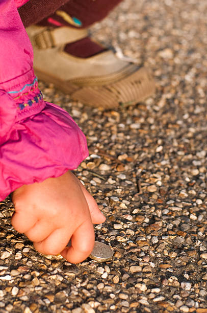 istock Child is picking money from floor 174684827