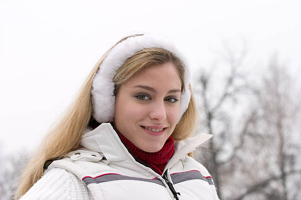 beautiful winter girl "beautiful young blond woman dressed in white, red scarf and earmuffs ..." jacraa2007 stock pictures, royalty-free photos & images