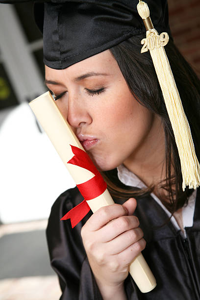 istock Female graduate kissing her new diploma 174685247
