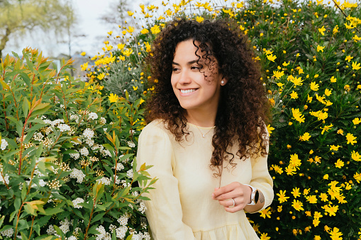 latin woman with curly hair enjoys spring
