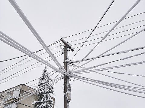 Damage to power lines due to heavy snowfall and severe weather conditions.