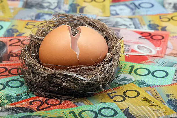 Photo of Broken Nest Egg on Australian currency notes cash money