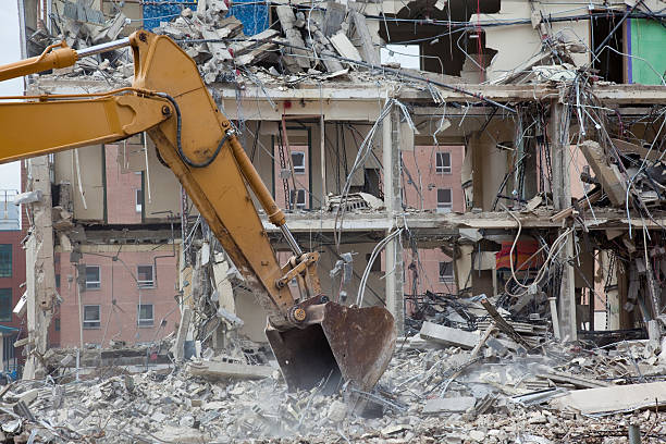 istock bull dozer demolishing building 174685939