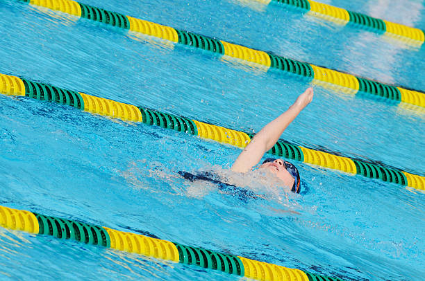 istock Young Boy Backstroke Swimmer Racing in Pool 174686190
