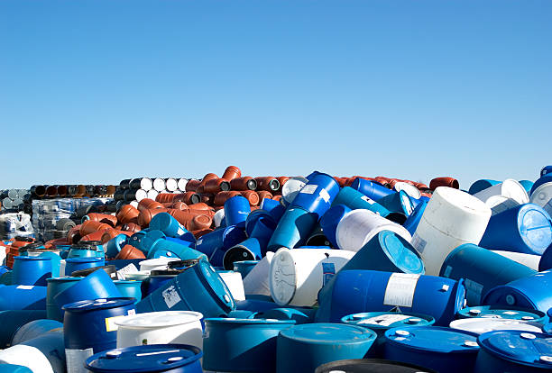 A plastic barrel and 45 gallon steel drum recycling storage area seems to extend to the horizon.