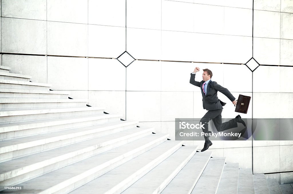 Ritardo Uomo d'affari in esecuzione all'aperto fino a lungo bianco scala - Foto stock royalty-free di Scalinata