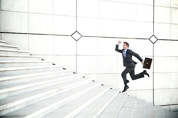 istock Late Businessman Running Outdoors Up Long White Staircase 174686393