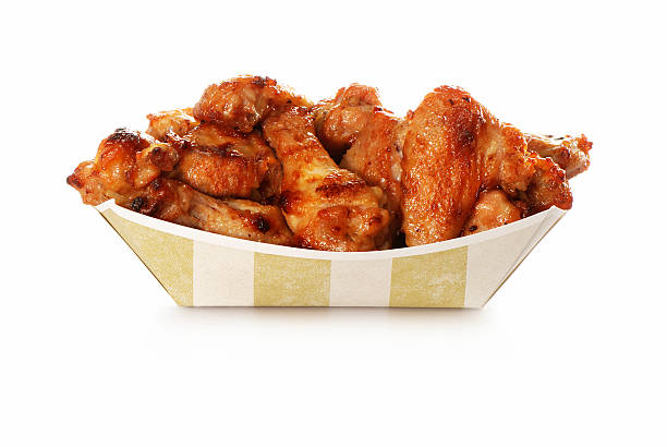 Chicken wings take out Stack of chicken wings in take out container. Check my wings lightbox. animal wing stock pictures, royalty-free photos & images