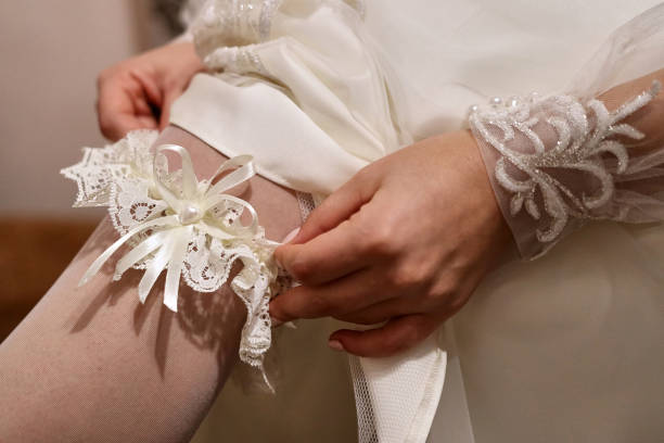 istock The bride wears a garter on her leg. Preparing for the wedding. 1746864374