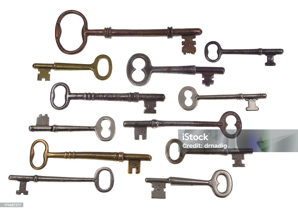 Antique Skeleton Keys Displayed on a White Background A collection of antique skeleton keys of various sizes isolated on a white background. Antique Stock Photo