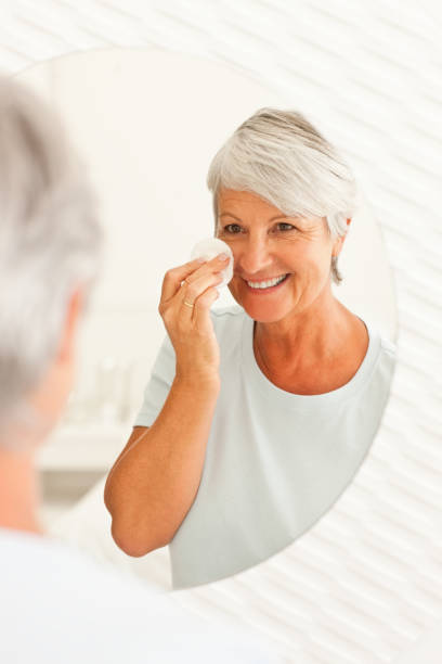 istock Senior woman putting on makeup 174687515