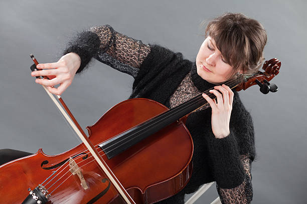 istock Young women play violoncello 174688079
