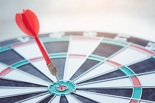 Business marketing success concept. Red dart arrow in center of the target dartboard. Bullseye is a target of business.