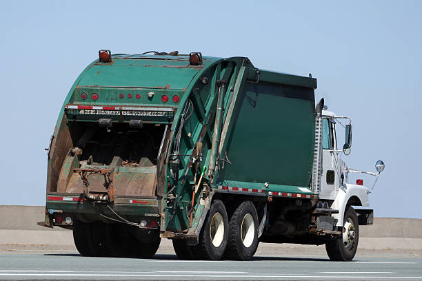 istock A garbage truck driving along an open road 174688287