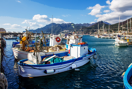 Small fishing ships in Harbor of Salerno - sunny autumn view- fantastic vacations for several day from norethern Europe (Thanks to low-cost airlines) . In distance - famous (Unesco site) Amalfi coast