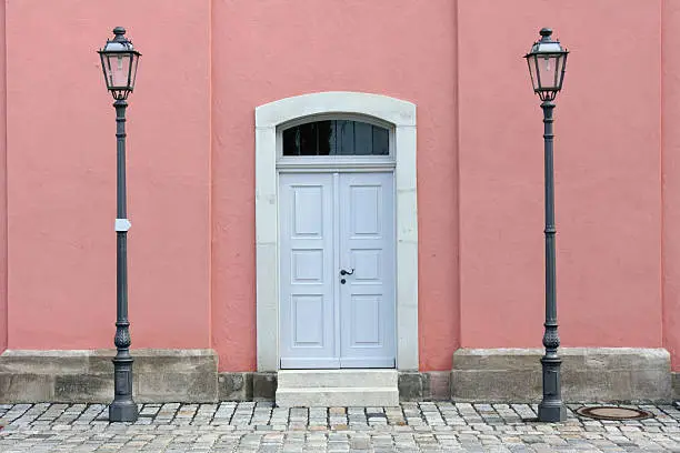 "The side door of a church with pink wall and streetlights. The right streetlight is slightly curved. Middle Franconia, Bavaria, Germany.More Doors And Windows In My Lightbox:"