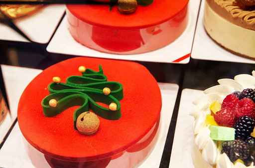 Cake with Christmas motif Red with green Spruce (Christmas) tree  on display in a store in Lugano