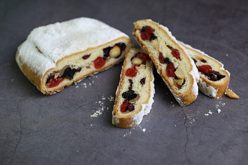 Sliced traditional Christmas stollen with decorations