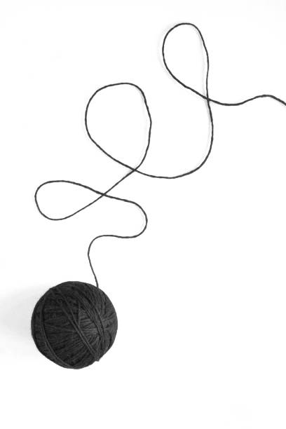 istock Black threads for knitting on the white background. Top view. Close-up. 1746895222
