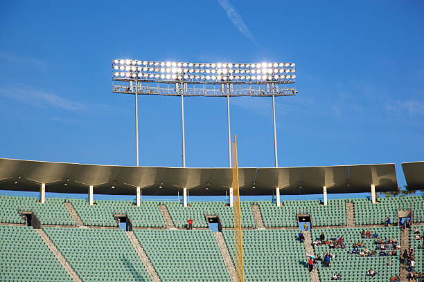 stadion lichter über dem oberen deck - floodlight blue sky day stock-fotos und bilder