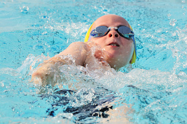 Please click my private lightbox links below for more images like this -- Thanks!A young male backstroke swimmer during a swim meet.
