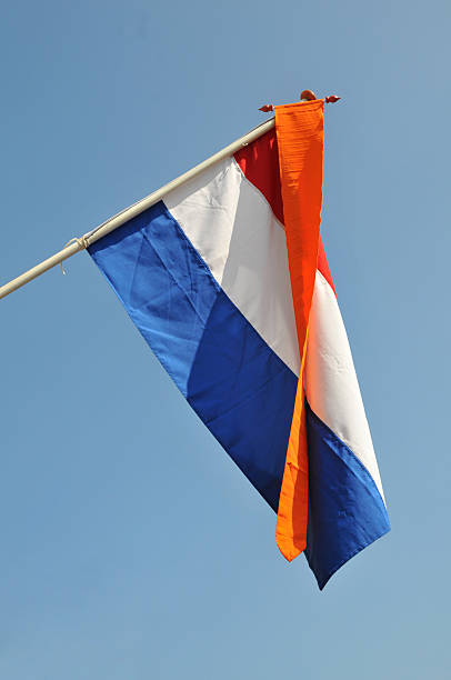 This Dutch flag waves in honour of 'Koninginnedag' , the day the Dutch celebrate the queens birtday. This year it was spoiled by a car attack on the royal family with  wounded and deads. 