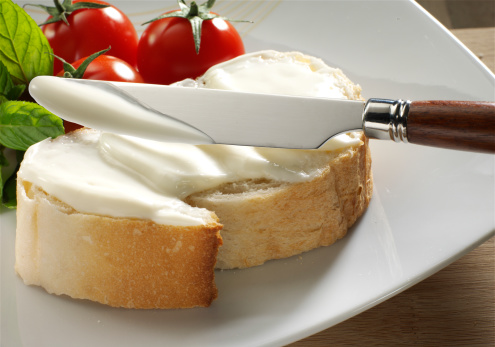 cream cheese on bread with tomato and mint