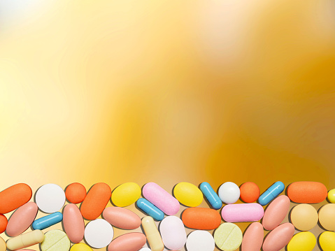 Healthcare and medicine concept. Colorful pills and medicine on defocused colored background with copy space