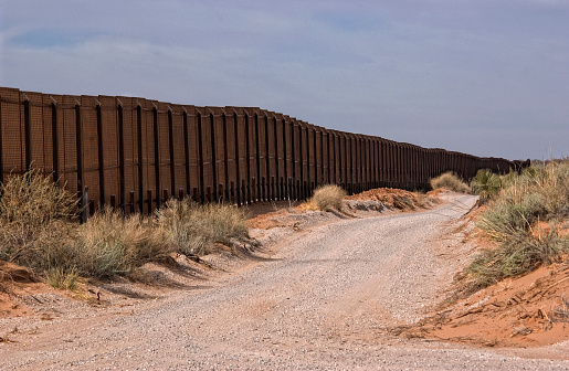 Gravel road along the Border fence between New Mexico, USA and the northern state of Chihuahua, Mexico.