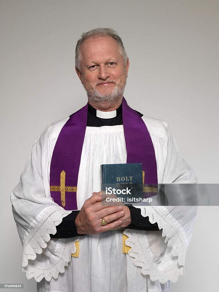 Priest and Bible Portrait of a priest holding the Bible 50-54 Years Stock Photo