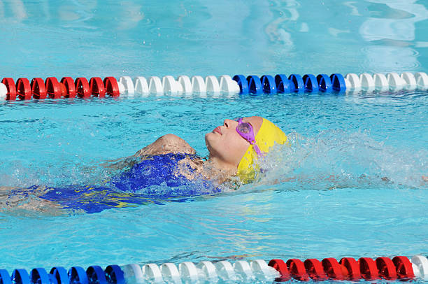 istock Young Girl Swimming Backstroke Race in Pool 174690838