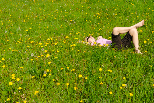 A woman is dreaming in middle of a meadow in Germany.Pics with this model