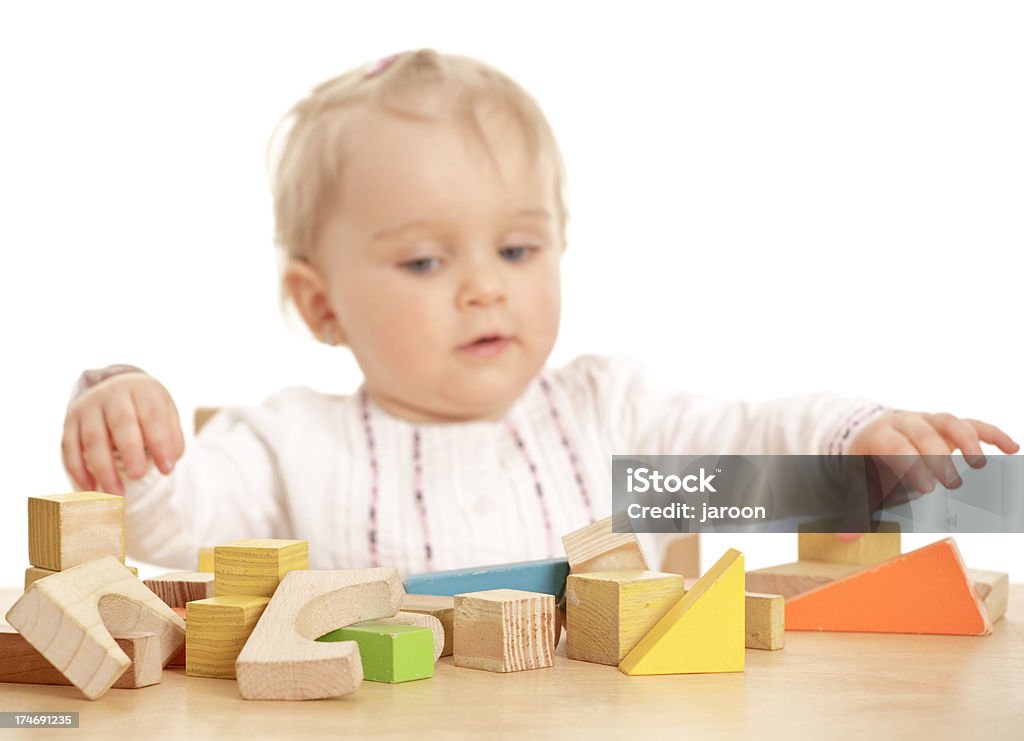 small baby girl with wooden blocks (focused on blocks) small baby girl isolated on white 12-17 Months Stock Photo