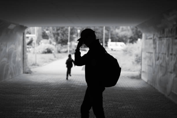 Madrid, Spain - 18 July 2018: Boy playing with ball near Caixa forum, famous modern building of Madrid. Madrid streets. City center of Madrid. Black and white photo