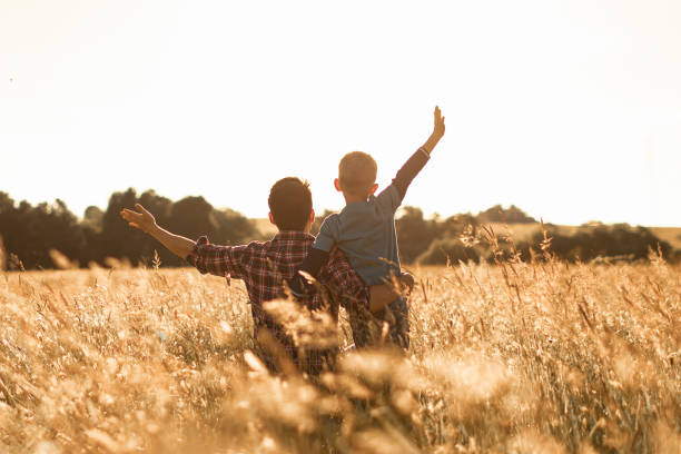 istock Happy father and son in the meadow. 1746922263
