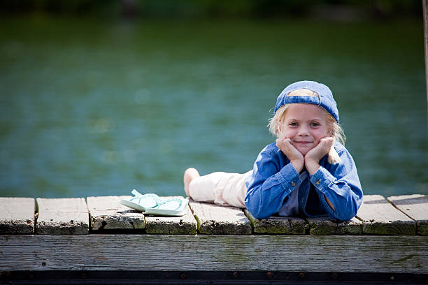 istock Little Girl Laying on Dock 174692300