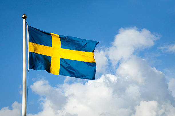 Swedish flag blowing in the wind on a sunny day.