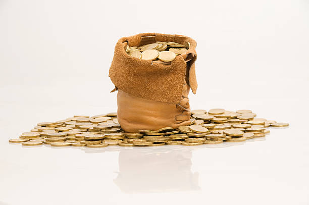 Treasure bag Leather bag full of cold coins isolated on white bag of coins stock pictures, royalty-free photos & images