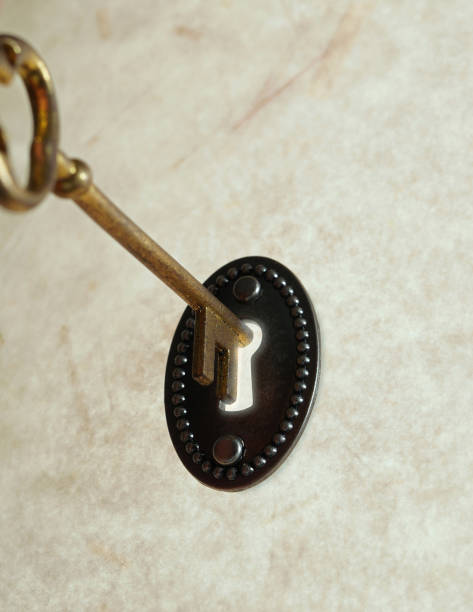 istock Antique gold key unlocking a vintage lock 1746925149
