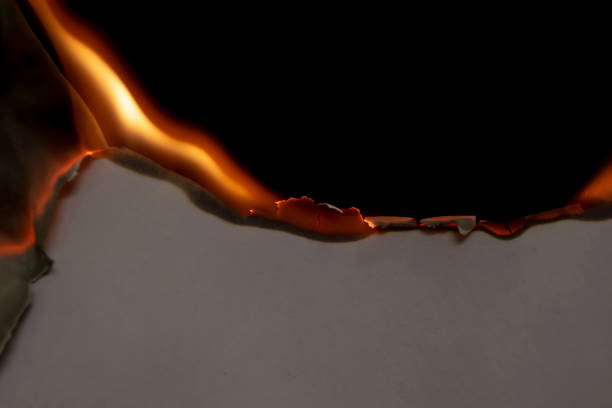 istock burning paper, glowing edge of paper on a black background 1746925730