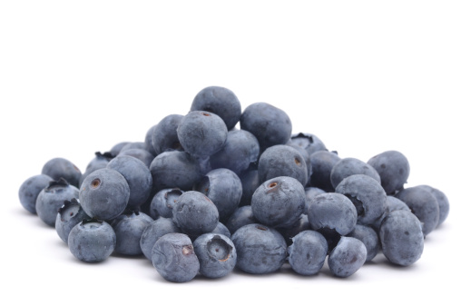 A close up shot of a pile of Blueberries isolated on white.
