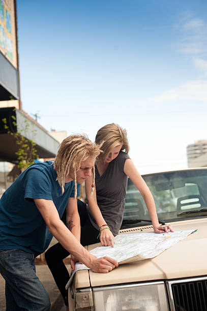 couple looking at map for road trip stock photo