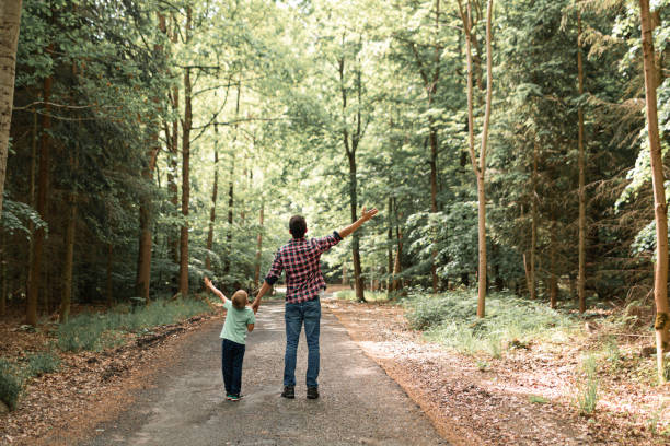 istock Father and son walking in the forest. 1746930560