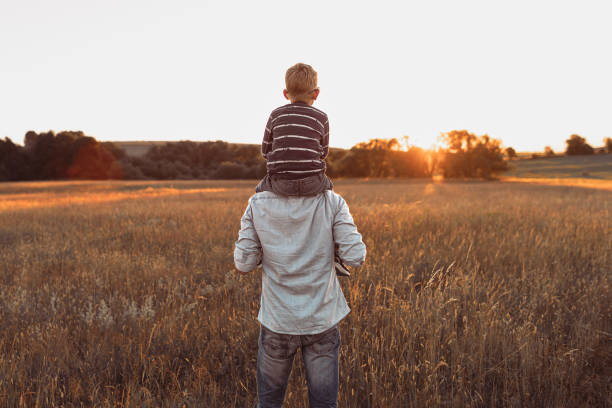 istock Father and son watching sunset together. 1746931704
