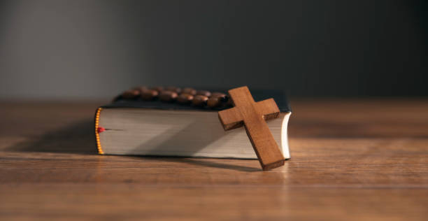 istock cross on open bible wooden table 1746936642