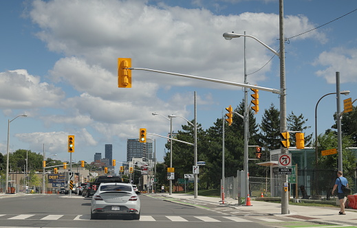 Toronto, Canada - August 27, 2023: Looking east on Eglinton Avenue West at Everden Road. Summer afternoon with clouds over the Cedarvale neighbourhood in York District.