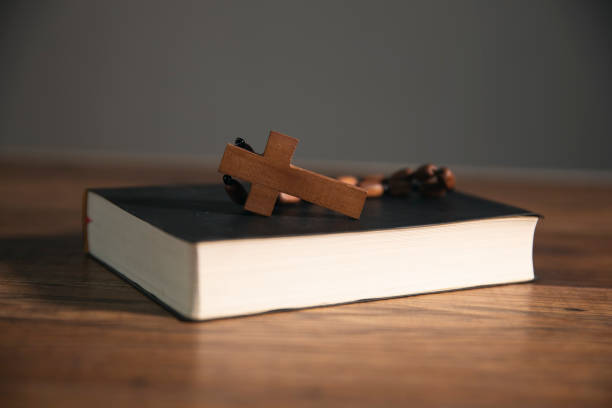 istock cross on open bible wooden table 1746936816